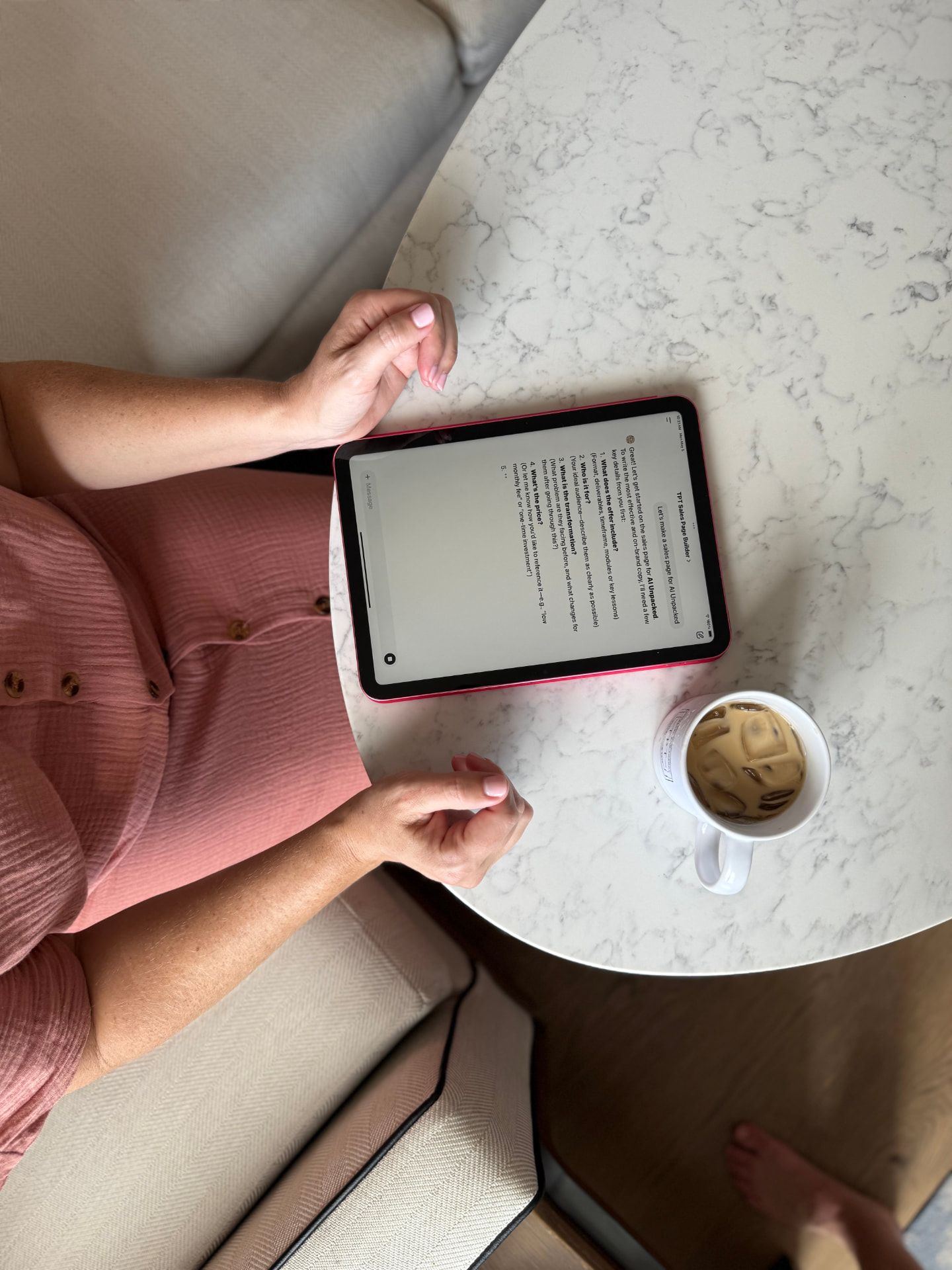 Kate Thomas working at a cafe table on an iPad